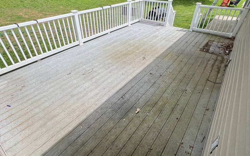 deck with white fencing before cleaning